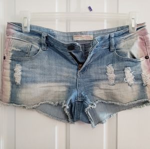 Faded jean shorts with a pink hue